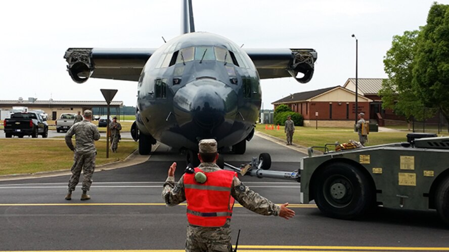 The 71st Aircraft Maintenance Unit paired with the 23d Civil Engineering Squadron to transport a retired HC-130P Combat King to the President George W. Bush Airpark May 14, 2015, at Moody Air Force Base, Ga. The 23d CES helped remove any obstacles such as tree branches or electrical posts during the move. (Courtesy photo)