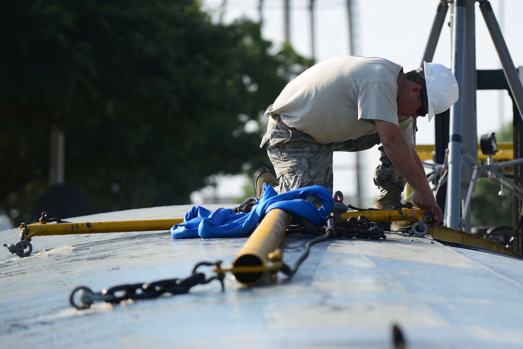 U.S. Air Force Tech. Sgt. David Poe, 71st Aircraft Maintenance Unit crew chief, secures a wing-sling to a retired HC-130P Combat King May 19, 2015, at Moody Air Force Base, Ga. The 71st AMU along with the 23d Civil Engineering Squadron assembled the aircraft in the President George W. Bush Airpark for Team Moody and visitors to view. (U.S. Air Force photo by Airman 1st Class Kathleen D. Bryant/Released)