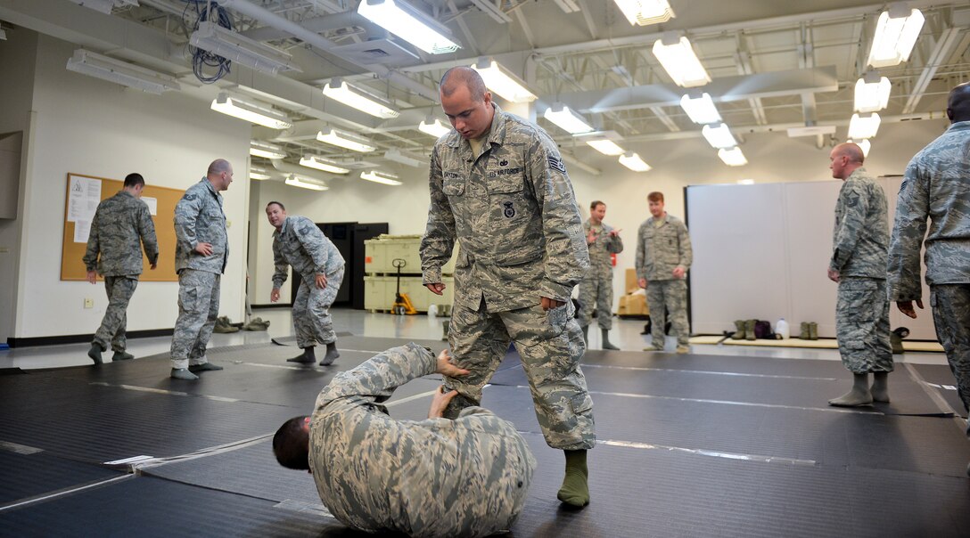 Staff Sgt. Daniel Dayton, 22nd Security Forces Squadron combatives program manager, mimics an attacker during a combatives training class June 9, 2015, at McConnell Air Force Base, Kan. Students learned different ways to defend, apprehend and create distance between themselves and a subject in real world situations. (U.S. Air Force photo by Senior Airman Colby L. Hardin)