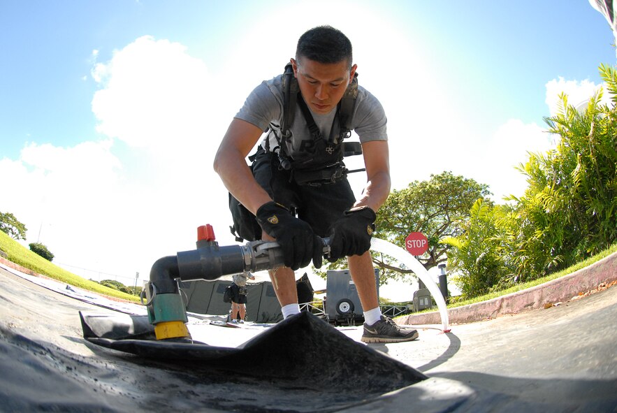 A soldier from the Hawaii National Guard Chemical, Biological, Radiological, Nuclear and Explosives (CBRNE) Enhanced Response Force Package (CERF-P) connects a wastewater discharge bladder to a mobile decontamination unit during Exercise Vigilant Guard/Makani Pahili 2015 at Queens Medical Center West Oahu, Hawaii, June 6, 2015. The exercise included Queens hospital emergency room personnel and soldiers from the Hawaii Army National Guard participating in a combined disaster and hurricane preparedness exercise sponsored by the U.S. Northern Command, National Guard Bureau and the Hawaii Emergency Management Agency. (U.S. Air National Guard photo by Airman 1st Class Robert Cabuco)