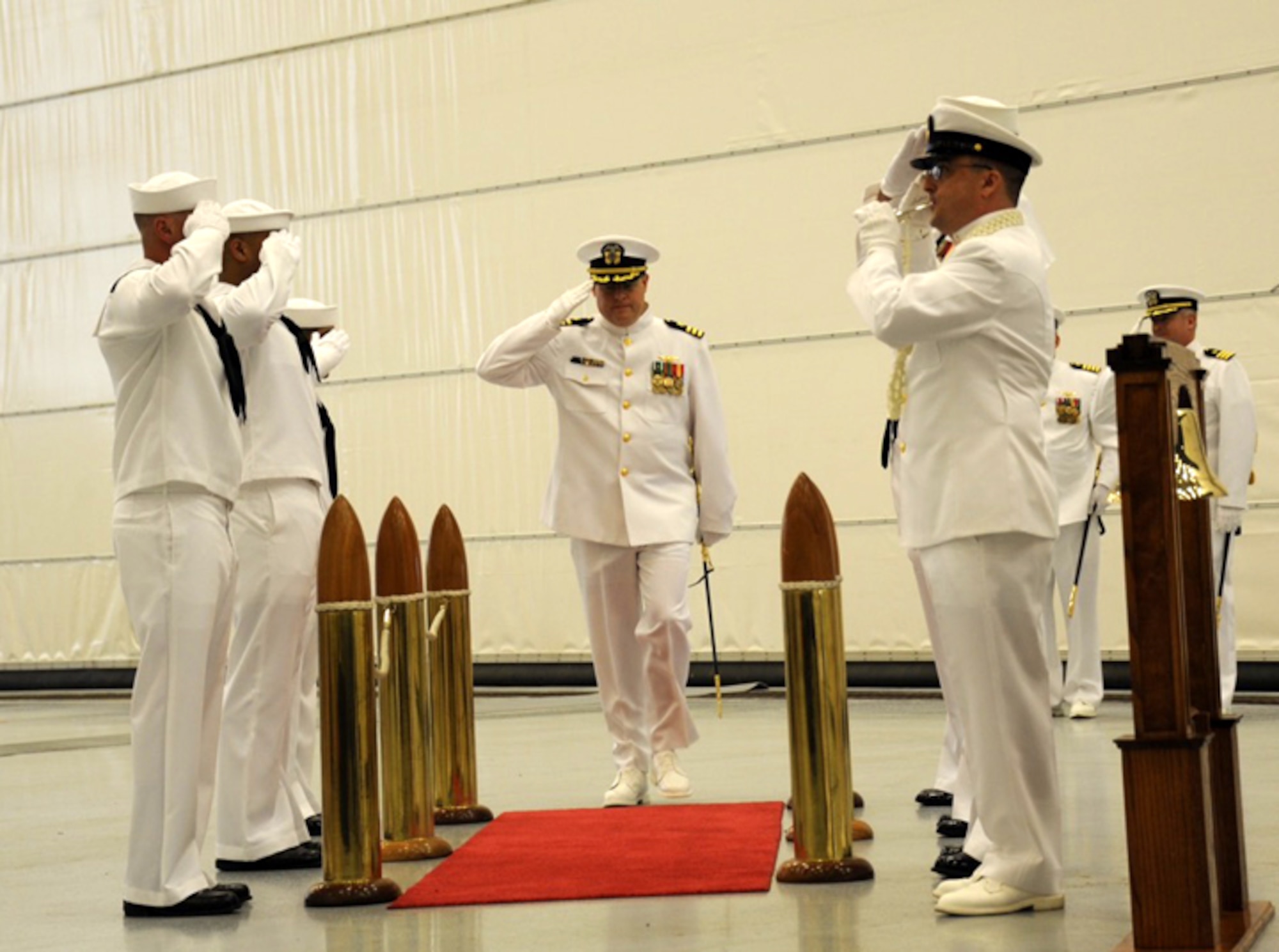 Navy Cmdr. Peter Moore, incoming commander and Yardley, Pa. native, is piped aboard by side boys from Fleet Logistics Support Squadron 64, during the squadron change of command ceremony held June 6, 2015, on Joint Base McGuire-Dix-Lakehurst, N.J. VR-64 is one of 15 Navy VR squadrons and one of five C-130T Hercules units. The ceremony was a formal farewell to Navy Cmdr. Todd Boland as the unit welcomed Moore. (U.S. Air Force photo by Pascual Flores/Released)