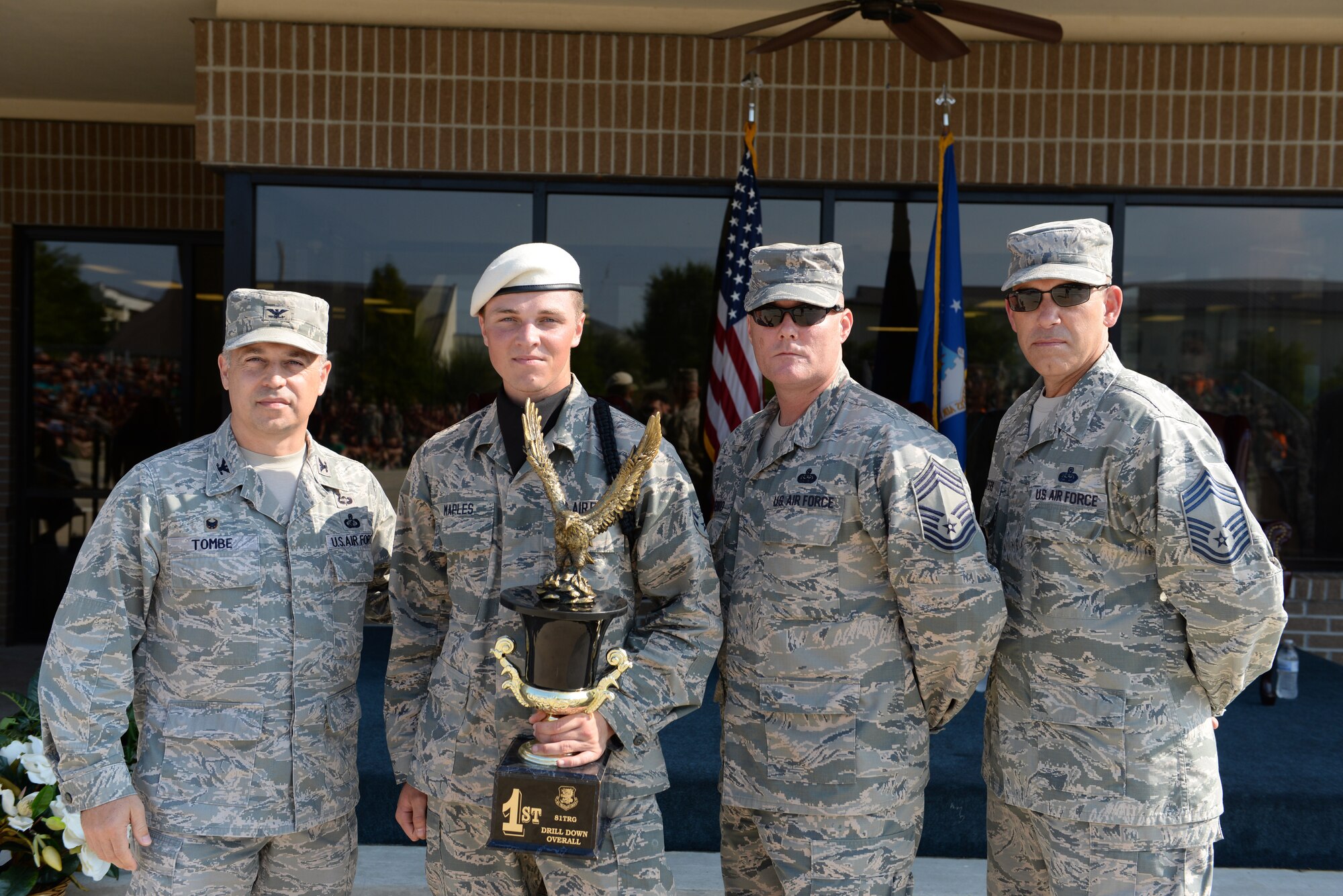 Airman 1st Class Cory Maples, 336th Training Squadron freestyle drill master, accepts the 1st place overall trophy from Col. George Tombe, 81st Training Group commander, Chief Master Sgt. Glen Usherwood, 81st Mission Support Group superintendent and Chief Master Sgt. Robert Winters, 81st TRG superintendent during the 81st TRG’s drill down competition June 5, 2015, at the Levitow Training Support Facility drill pad, Keesler Air Force Base, Miss. The 336th TRS “Red Wolves” placed 3rd in open ranks, 2nd in regulation, 1st in freestyle, and 1st overall. (U.S. Air Force photo by Airman 1st Class Duncan McElroy)