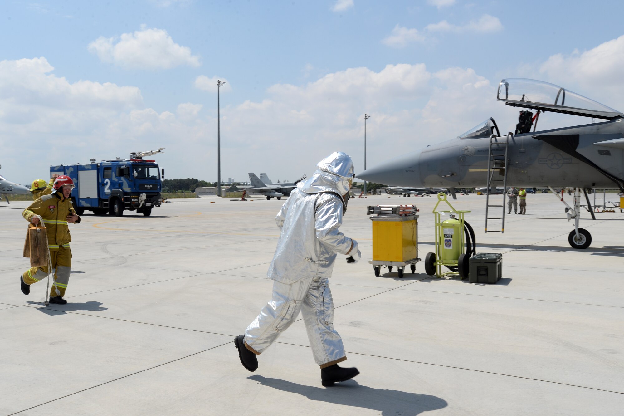 Tech. Sgt. Jeremy Hill, 48th Civil Engineer Squadron station chief, center, observes Turkish Air Force firefighters in a proficiency exercise scenario during Anatolian Eagle 15 at 3rd Main Jet Base, Konya, Turkey, June 11, 2015. The scenario involved inspecting an aircraft after a reported in-flight emergency for fuel or hydraulic leaks, to establish the scene as "fire safe" for maintenance airmen to further inspect the aircraft. (U.S. Air Force photo by Tech. Sgt. Eric Burks/Released)