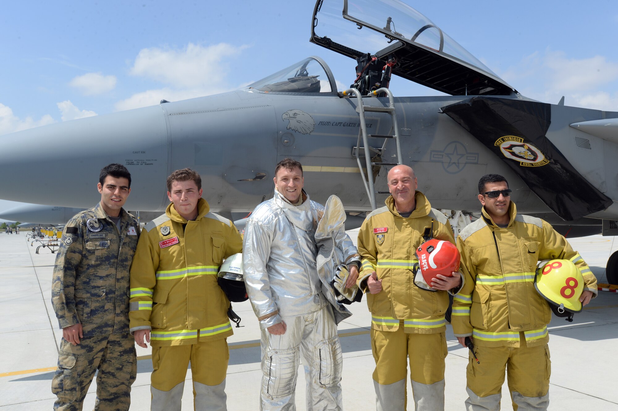 Tech. Sgt. Jeremy Hill, 48th Civil Engineer Squadron station chief, center, stands with Turkish Air Force firefighters for a group photo following a proficiency exercise scenario during Anatolian Eagle 15 at 3rd Main Jet Base, Konya, Turkey, June 11, 2015. Hill is one of about 250 personnel from the 48th Fighter Wing, Royal Air Force Lakenheath, England, participating in Anatolian Eagle. (U.S. Air Force photo by Tech. Sgt. Eric Burks/Released)