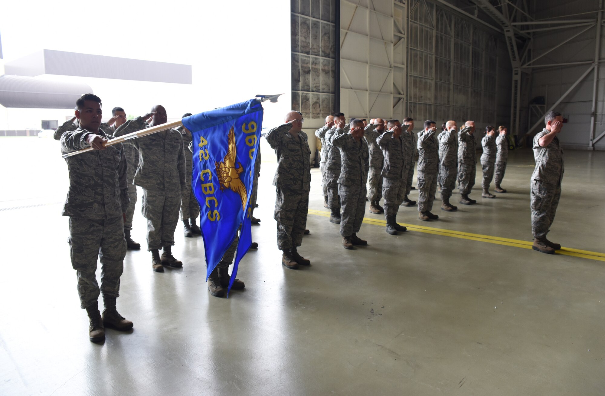 The 42d Combat Communications Squadron presents its guidon for the last time. The squadron transitioned from the 514th Air Mobility Wing, here to the 960th Cyberspace Operations Group, Joint Base San Antonio, Lackland, Tx., in 2009. The geographically separated unit continued to provide services and received administrative support from the 514th AMW.