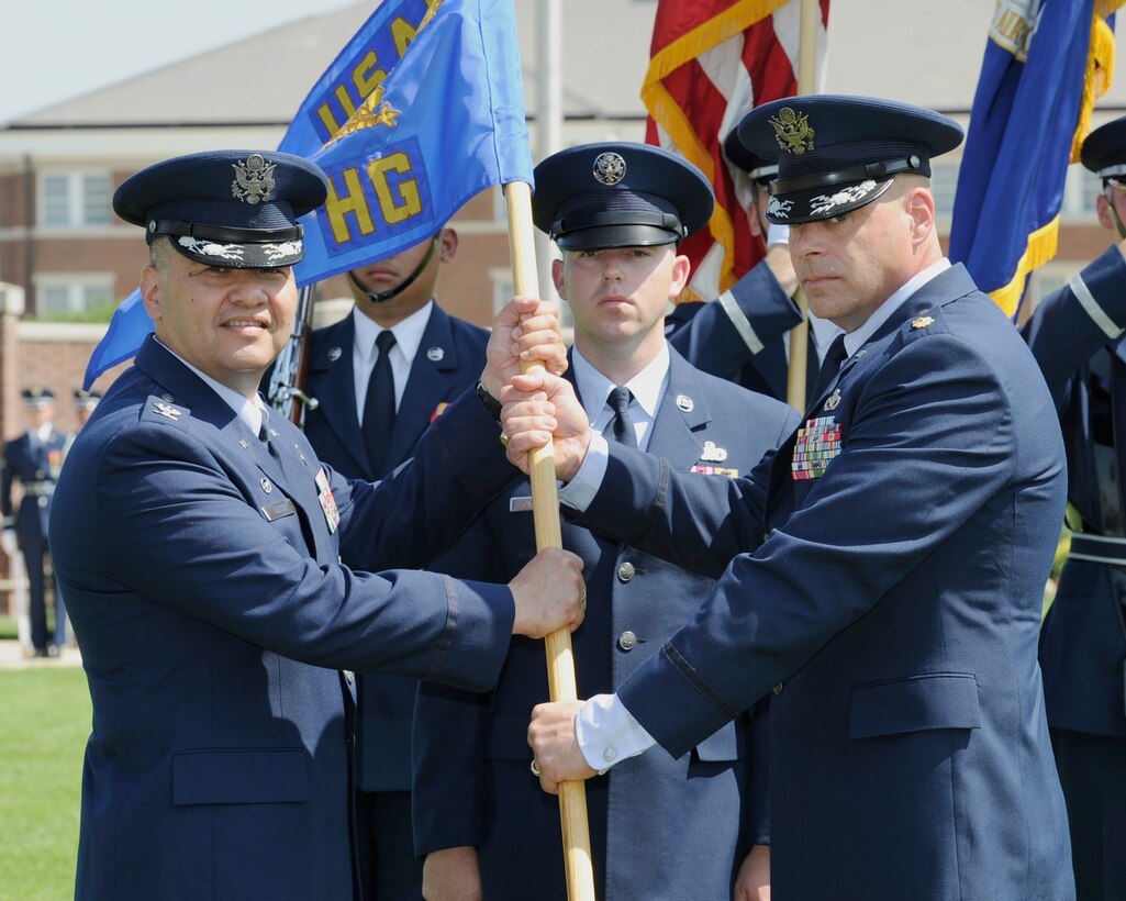 Maj. Peter Tritsch Jr., right, incoming U.S. Air Force Honor Guard commander, accepts the U.S. Air Force Honor Guard guidon from Col. Richard Lindlan, 11th Operations Group commander, during a change of command ceremony June 12, 2015, at Joint Base Anacostia-Bolling, D.C. The passing of the unit guidon during a change of command ceremony is a symbolic representation of passing authority from the outgoing commander to the incoming commander. (U.S. Air Force photo by Senior Airman Preston Webb/Released)