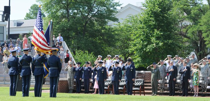 Attendees render courtesy to the U.S. Flag while the national anthem plays during a change of command ceremony June 12, 2015, at Joint Base Anacostia-Bolling, D.C. These ceremonies mark a formal transfer of command from an outgoing to an incoming commander. (U.S. Air Force photo by Senior Airman Preston Webb/Released)