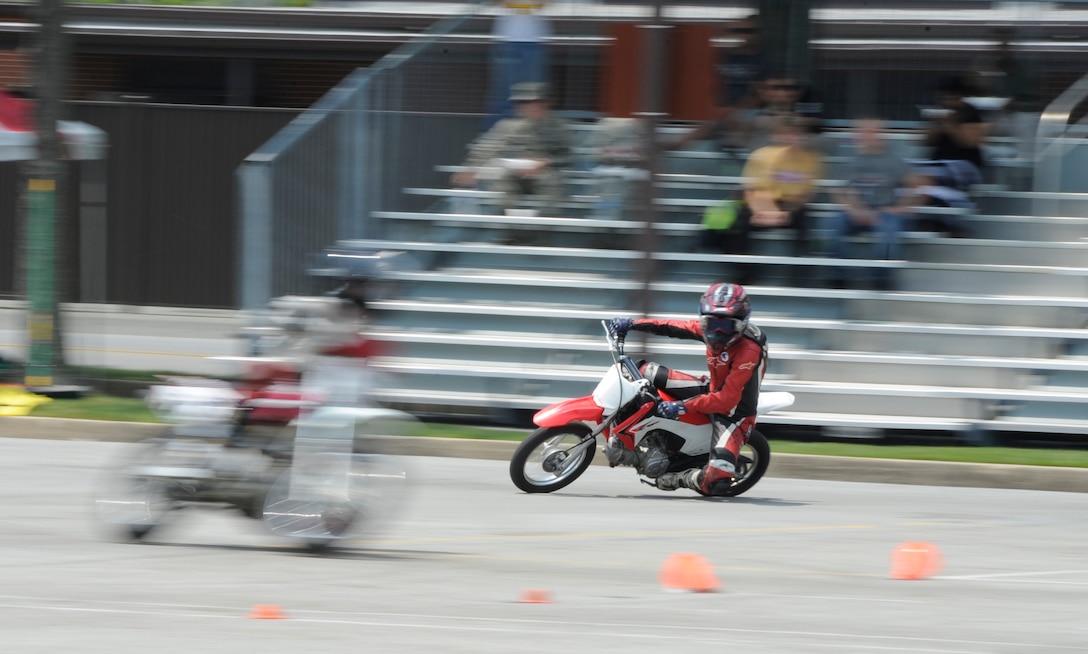 Mikayla Moore, professional mini motard racer, demonstrates maneuvers at the Fifth Annual Motorcycle Safety Day June 11, 2015, at Joint Base Andrews, Md. The safety day included various demonstrations to educate Team Andrews members about safe riding practices. (U.S. Air Force photo by Senior Airman Preston Webb/Released)

