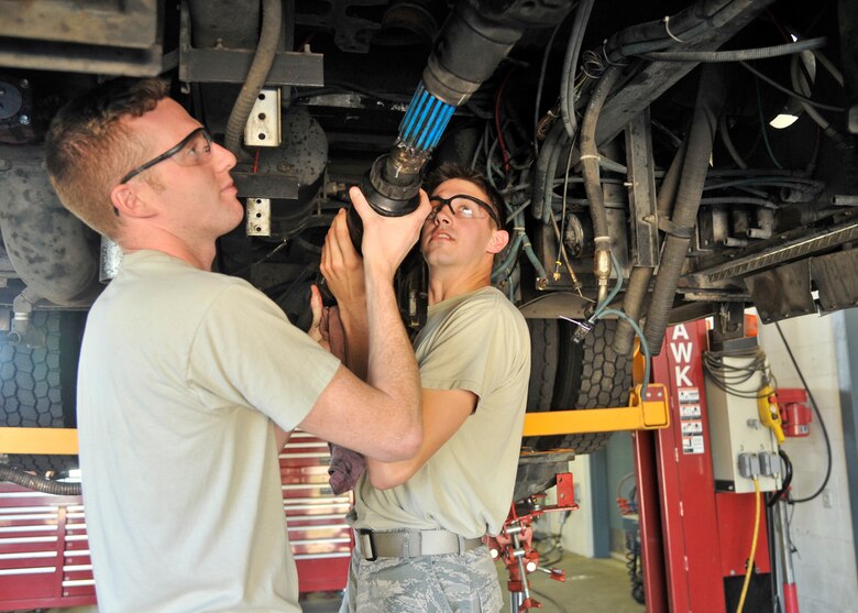 Senior Airmen Brent Donaldson and Jesse Scholle, both 92nd Logistics Readiness Squadron fire truck maintainers, fix the drive shaft on a fire truck June 8, 2015, at Fairchild Air Force Base, Wash. Donaldson and Scholle go from front to rear bumper checking everything on these trucks ensuring they are in service on a daily basis. The maintainers troubleshoot different problems ranging from burnt out light bulbs to a broken water pump. (U.S. Air Force photo/Airman 1st Class Taylor Bourgeous)