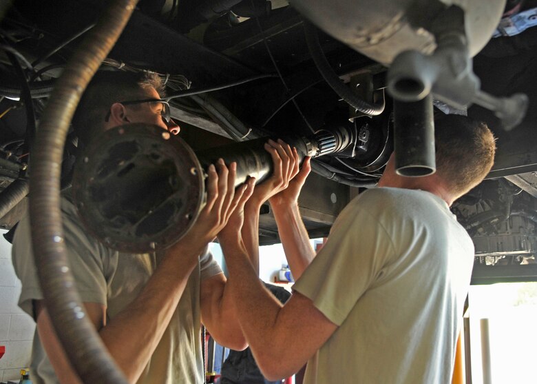 Senior Airmen Jesse Scholle and Brent Donaldson, both 92nd Logistics Readiness Squadron fire truck maintainers, install a drive shaft back into a fire truck June 8, 2015, at Fairchild Air Force Base, Wash. A fire truck maintainer’s job includes changing the oil, replacing the wiper blades, switching out tires and even replacing water pumps. (U.S. Air Force photo/Airman 1st Class Taylor Bourgeous)
