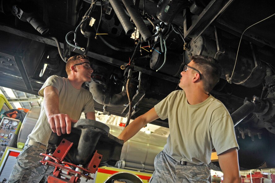 Senior Airmen Brent Donaldson and Jesse Scholle, both 92nd Logistics Readiness Squadron fire truck maintainers, look at the undercarriage of a fire truck June 8, 2015, at Fairchild Air Force Base, Wash. Donaldson and Scholle perform maintenance checks on all of the fire trucks to ensure they are in serviceable condition. The preventative maintenance they do is key to help keep the longevity of the trucks in service. (U.S. Air Force photo/Airman 1st Class Taylor Bourgeous)