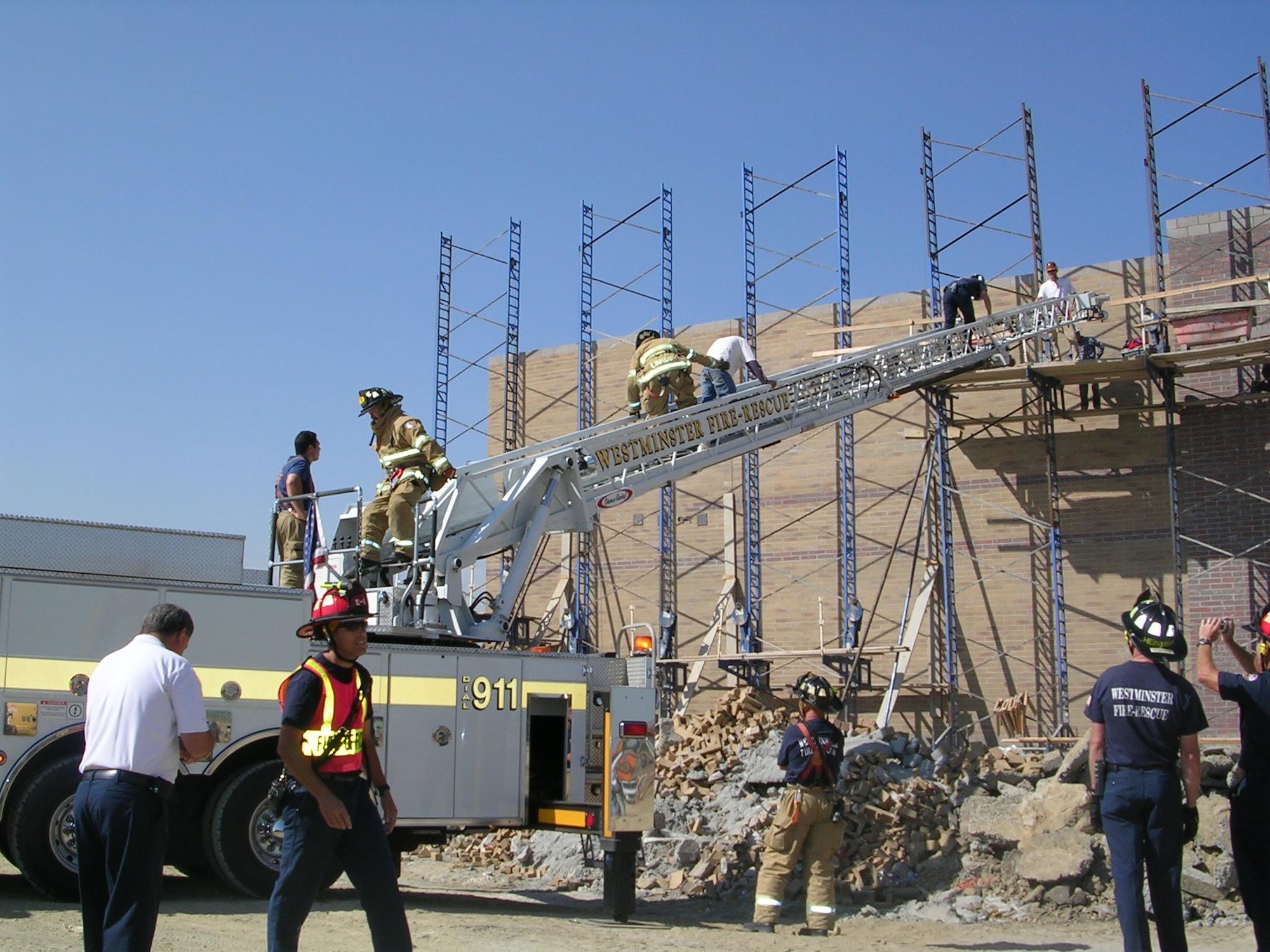 Senior Airman Darrell Linkus, explosive ordnance disposal operator with the 140th Explosive Ordnance Disposal Flight, 140th Wing, Colorado Air National Guard, assists people down the rescue ladder while performing his full-time job as a firefighter with the Westminster Fire Department. (Photo courtesy of Senior Airman Darrell Linkus)