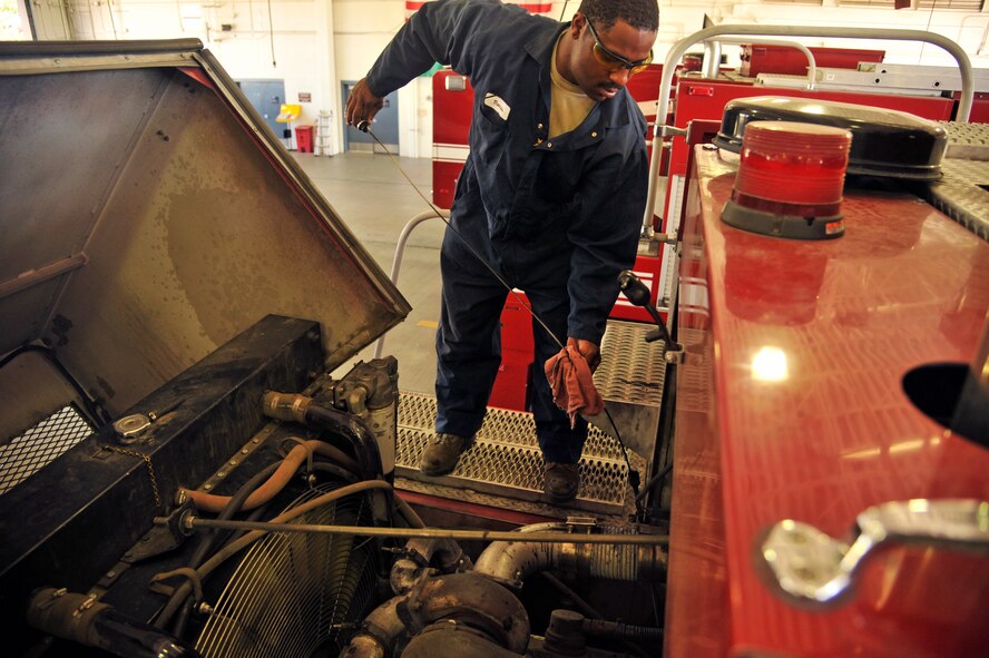 Airman 1st Class Garian Thomas, 92nd Logistics Readiness Squadron fire truck maintainer, checks the oil in a fire truck June 8, 2015, at Fairchild Air Force Base, Wash. Thomas changes the oil in the trucks to help maintain their longevity. Maintaining the fire trucks is an important job, he said, because if the trucks were to break down it could lead to serious damage and possibly loss of life. (U.S. Air Force photo/Airman 1st Class Taylor Bourgeous)