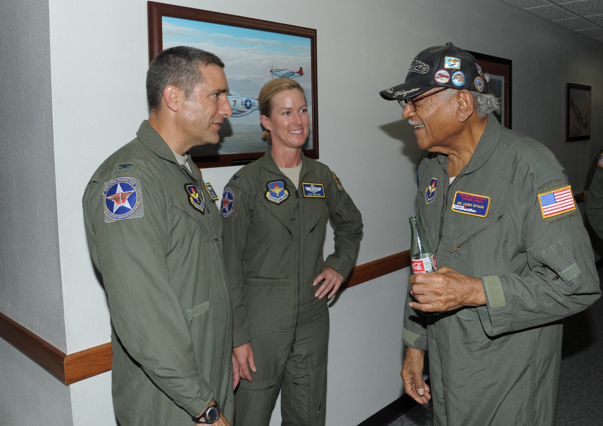 Col. Matthew Isler, left, 12th Flying Training Wing commander and Col. Jodi Perkins, 12th Flying Training Wing vice commander speak to James Bynum, Tuskegee Airman, during the Tuskegee Airmen Tribute 2015, June 11, at Joint Base San Antonio-Randolph. The Tuskegee Airmen were the first African-American military aviators in the United States Armed Forces beginning in World War II.(U.S. Air Force photo by Joel Martinez)