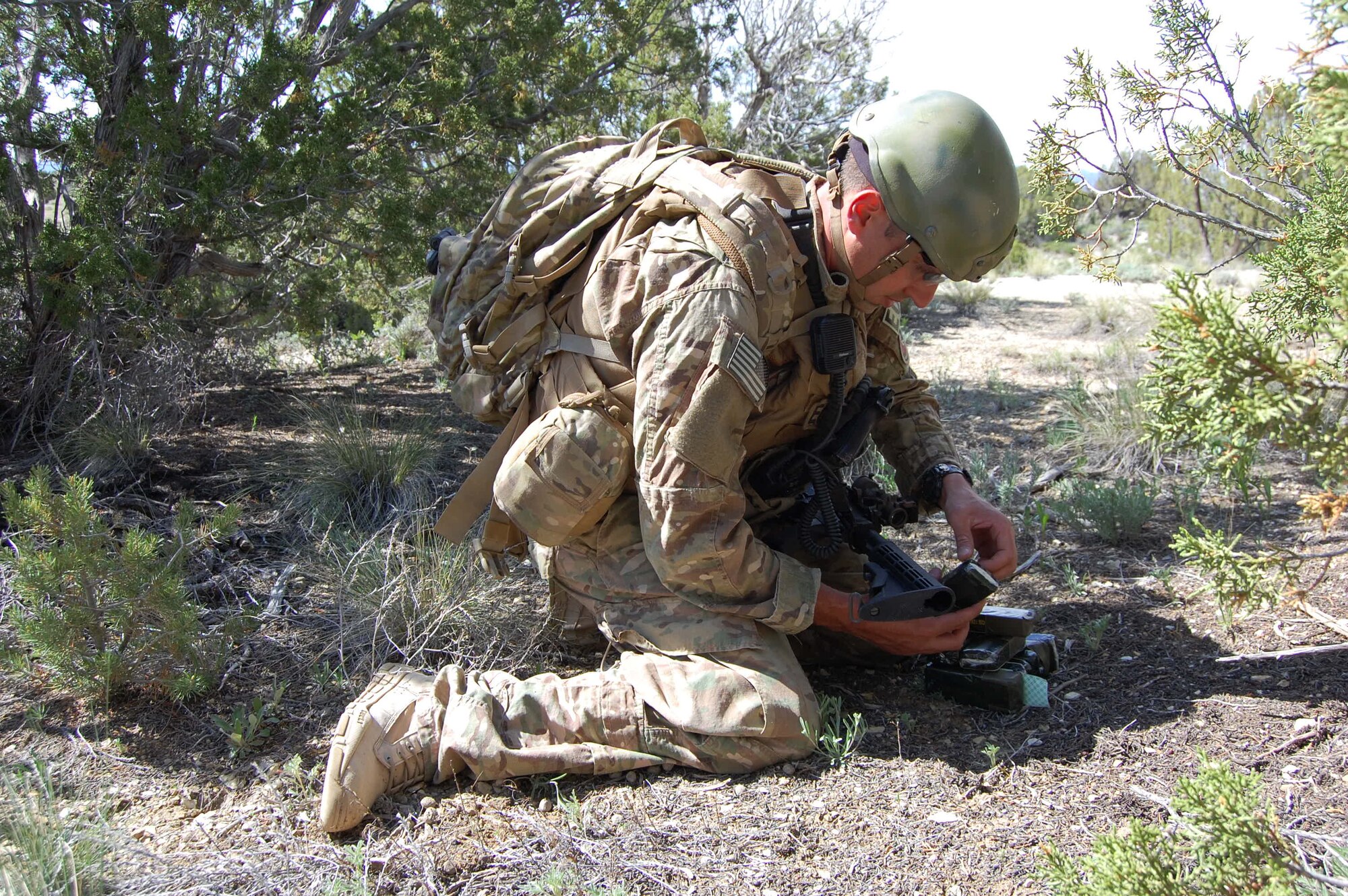 Senior Airman Darrell Linkus, explosive ordnance disposal operator with the 140th Explosive Ordnance Disposal Flight, 140th Wing, Colorado Air National Guard, builds an explosive device to destroy a weapon cache during a training exercise at Airburst Range, Ft. Carson, Colo. May 12, 2015.  (Air National Guard photo by Capt. Kinder Blacke)