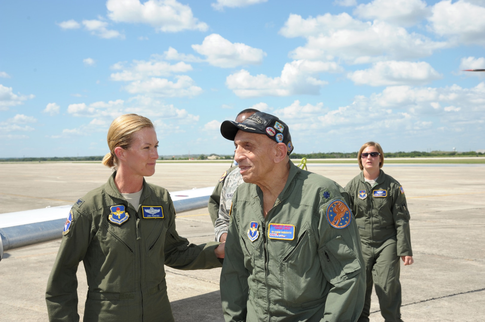 Col. Jodi Perkins, 12th Flying Training Wing vice commander greets Dr. Eugene Derricote, an original Tuskegee Airman, , during the Tuskegee Airmen Tribute 2015, June 11, at Joint Base San Antonio-Randolph. The Tuskegee Airmen were the first African-American military aviators in the United States Armed Forces beginning in World War II.  (U.S. Air Force photo by Joel Martinez)