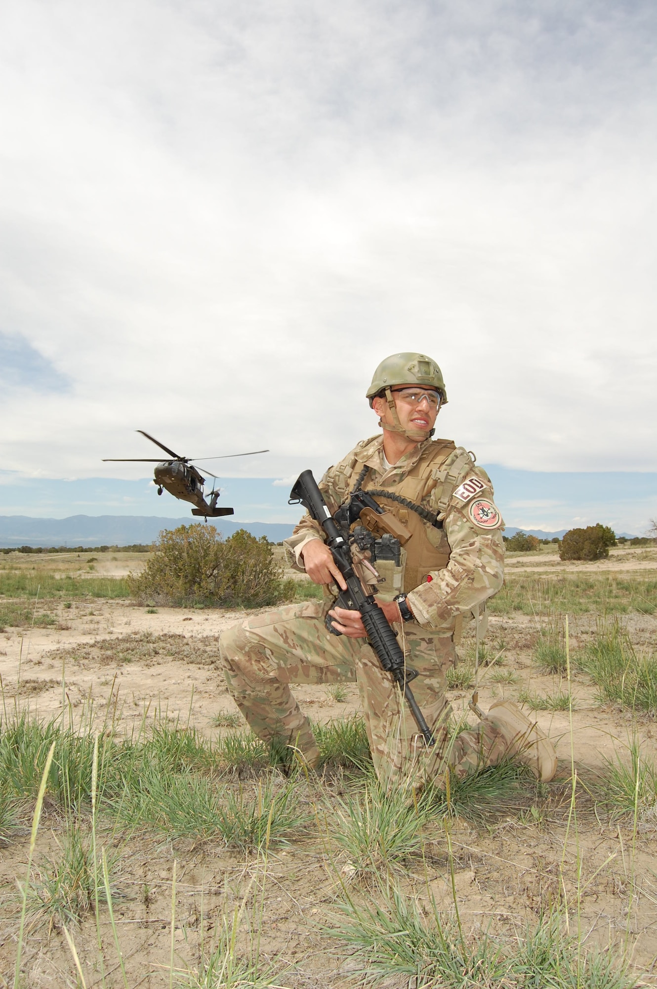 Senior Airman Darrell Linkus, explosive ordnance disposal operator with the 140th Explosive Ordnance Disposal Flight, 140th Wing, Colorado Air National Guard, waits to be picked up by a Colorado Army National Guard Blackhawk helicopter during a training exercise at Airburst Range, Ft. Carson, Colo. May 12, 2015.  (Air National Guard photo by Capt. Kinder Blacke)
