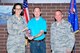 MCGHEE TYSON AIR NATIONAL GUARD BASE, Tenn. - Col. Jessica Meyeraan, commander of the I.G. Brown Training and Education Center, left, and Chief Master Sgt. Andy Traugot, TEC division chief, right, hand a crystal cup to Mr. Dustin C. Russell, an instructional systems specialist with the Media and Engagement Division. The award honors Russell, who is the Air National Guard Readiness Center Category 2 Civilian of the Year. (U.S. Air National Guard photo by Master Sgt. Jerry Harlan/Released)
