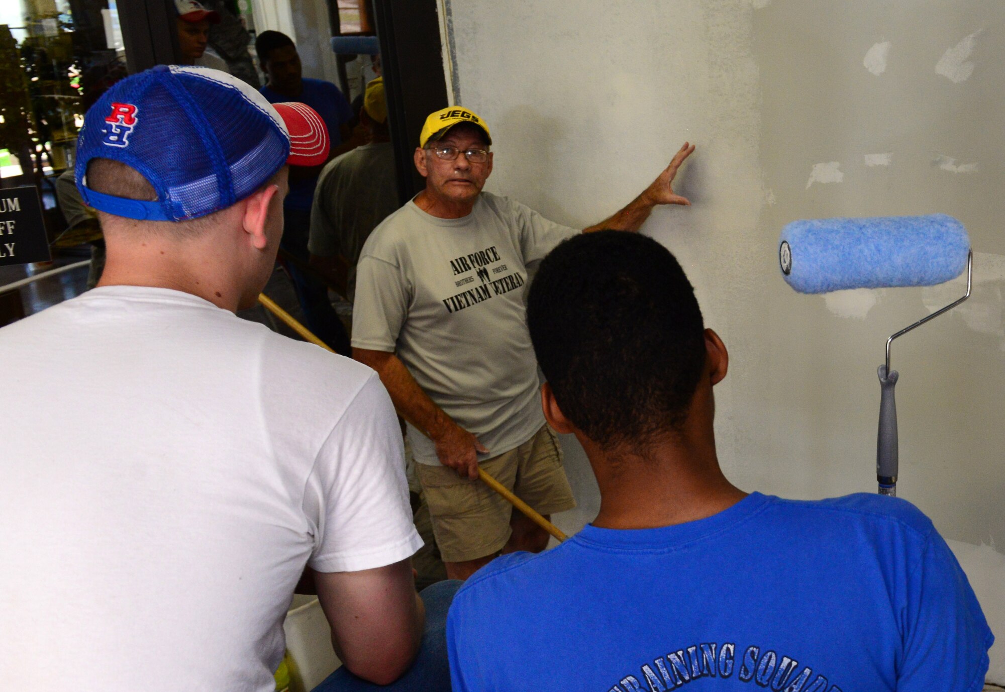 Bill Armstrong, a civilian, teaches Airmen how to texturize the walls at the Global Power Museum on Barksdale Air Force Base La., June 9, 2015. Armstrong is overseeing the Airmen as they repair sheetrock, texturize the walls, and paint.  (U.S. Air Force Photo/Airman 1st Class Luke Hill)