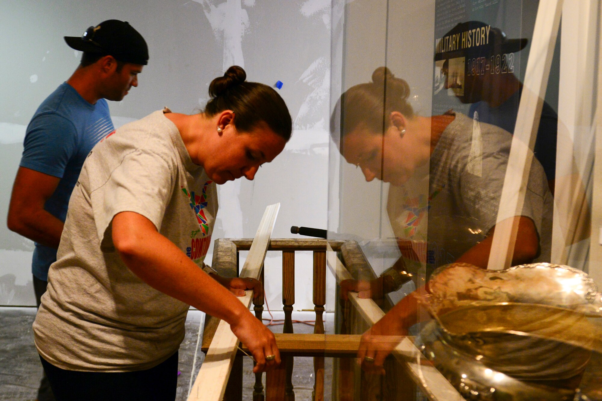 Staff Sgt. James Hulett, 20th Aircraft Maintenance Unit, and Amy Russell, Global Power Museum director, repair trim used around doorways in the Global Power Museum on Barksdale Air Force Base, La., June 8, 2015. In one week the Museum will have newly texturized and painted walls and waxed and finished floors. (U.S. Air Force Photo/Airman 1st Class Luke Hill)