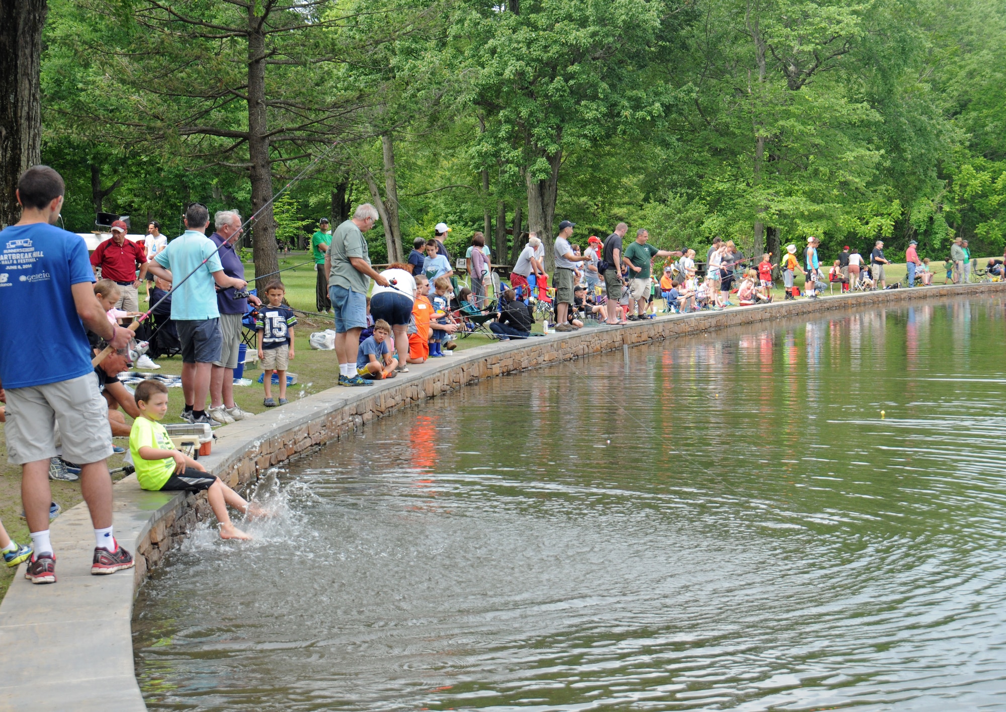 Hundreds of area residents are elbow-to-elbow lining the freshly stocked pond at Kohler Park June 6, 2015, Horsham, Pennsylvania. The pond was stocked for the township’s annual Horsam Day celebration. (U.S. Air National Guard photo by Staff Sgt. Michael Shaffer/released)