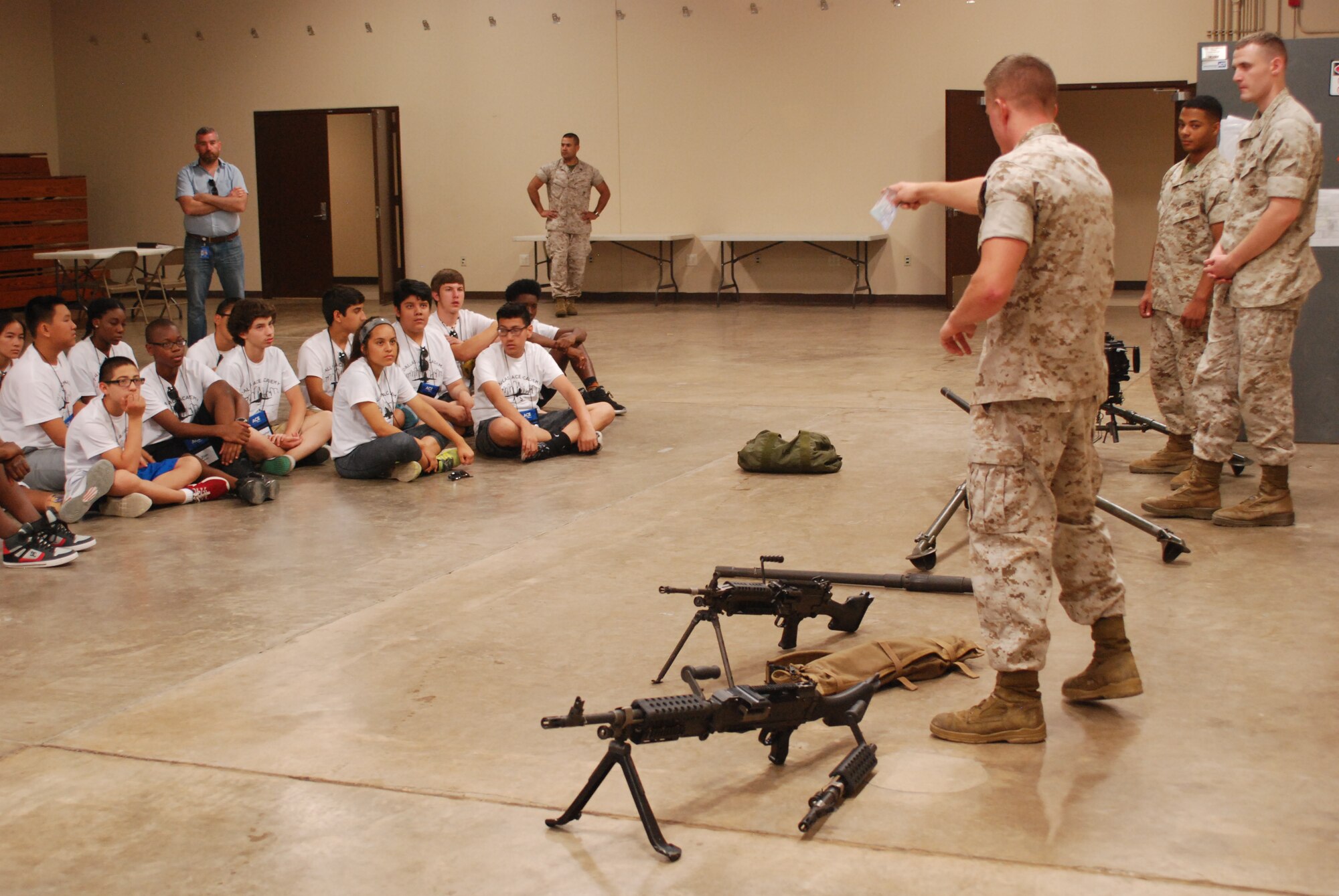 Students from the Dallas Aviation Career Education Academy watch a presentation from members of the 14th Marine Regiment at Naval Air Station Fort Worth Joint Reserve Base, Texas Thursday, June 11. The 14th Marines, one of many tenants visited during the base tour, delivered a presentation that covered aspects of four different types of weapons used by Marines. (U.S. Air Force photo by Senior Airman Ben Calantas)