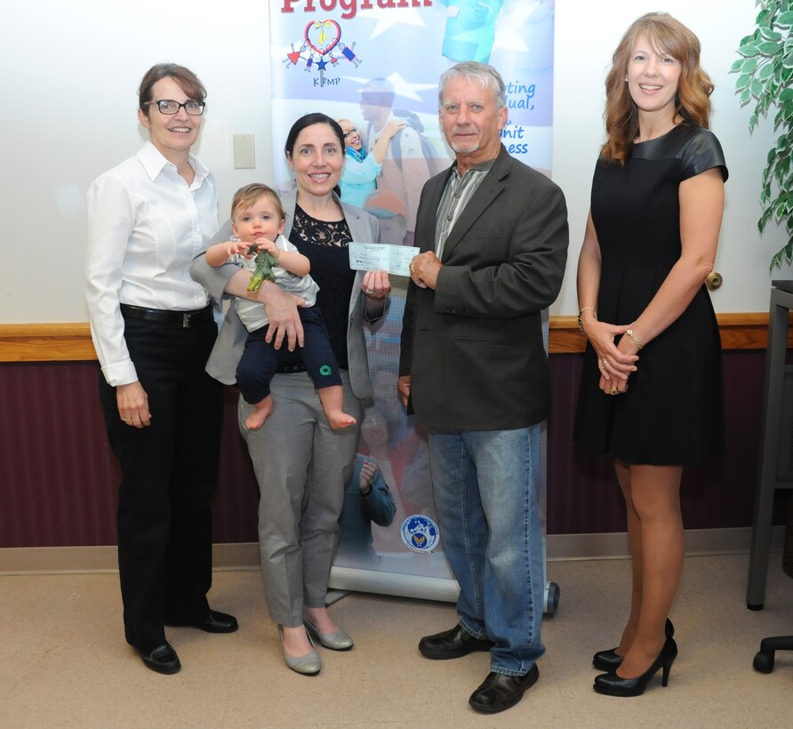 Dennis Brochey (center), Lewiston Town Supervisor presents a check on behalf of the Red Brick Bench Press Championships  to Gina Pizziconi Cupples , president, Friends of Family Support Association, Patty Braun (far left), executive officer, 914th Airlift Wing, and Holly Curcione (far right), executive administrative assistant, Niagara Military Affairs Council, at the Niagara Falls Air Reserve Station on June 5, 2015. More than $11,000 was raised to assist the FFSA, Armed Forces members and their families. (U.S. Air Force photo by Staff Sgt. Matthew Burke) 