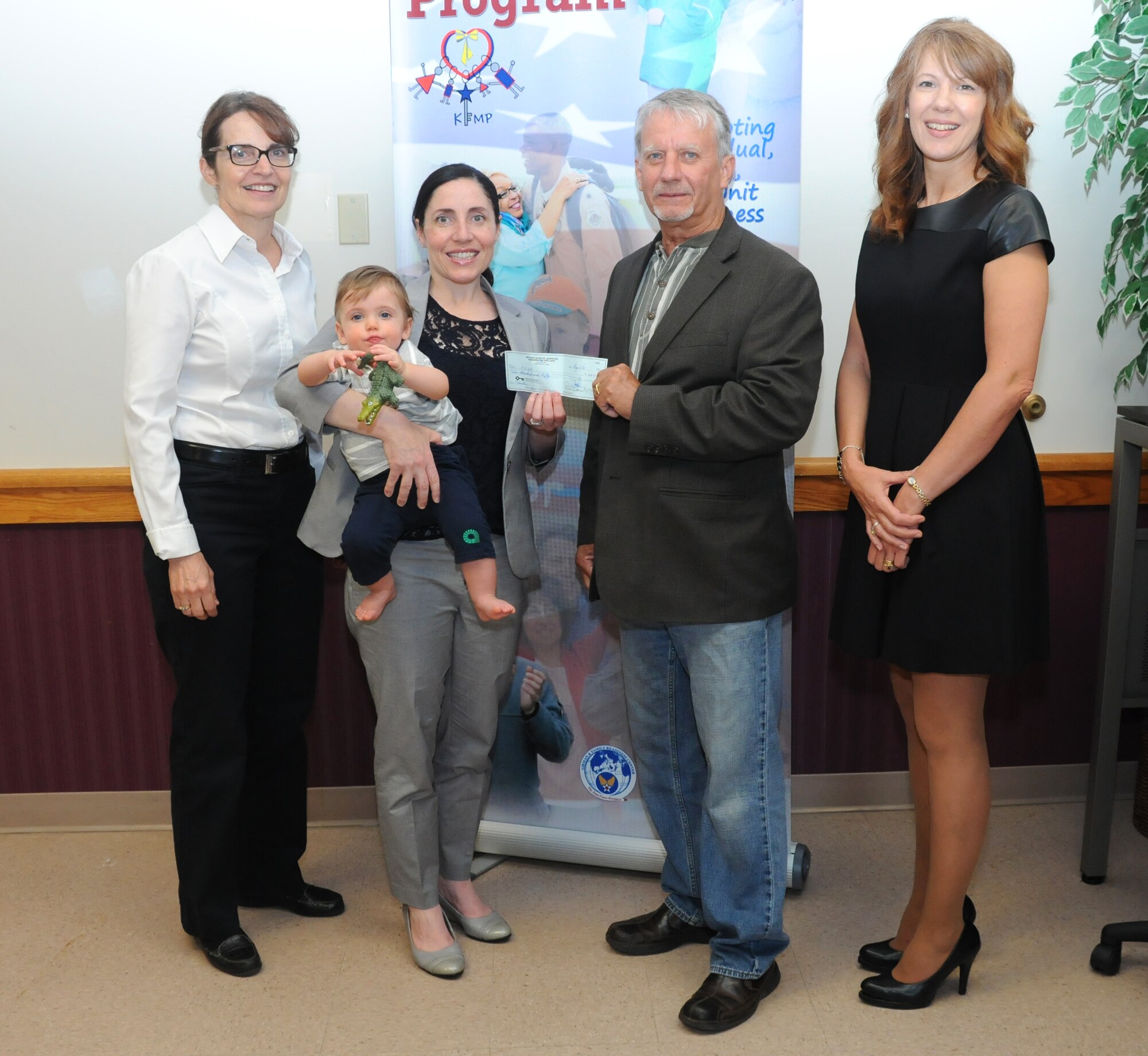 Dennis Brochey (center), Lewiston Town Supervisor presents a check on behalf of the Red Brick Bench Press Championships  to Gina Pizziconi Cupples , president, Friends of Family Support Association, Patty Braun (far left), executive officer, 914th Airlift Wing, and Holly Curcione (far right), executive administrative assistant, Niagara Military Affairs Council, at the Niagara Falls Air Reserve Station on June 5, 2015. More than $11,000 was raised to assist the FFSA, Armed Forces members and their families. (U.S. Air Force photo by Staff Sgt. Matthew Burke) 