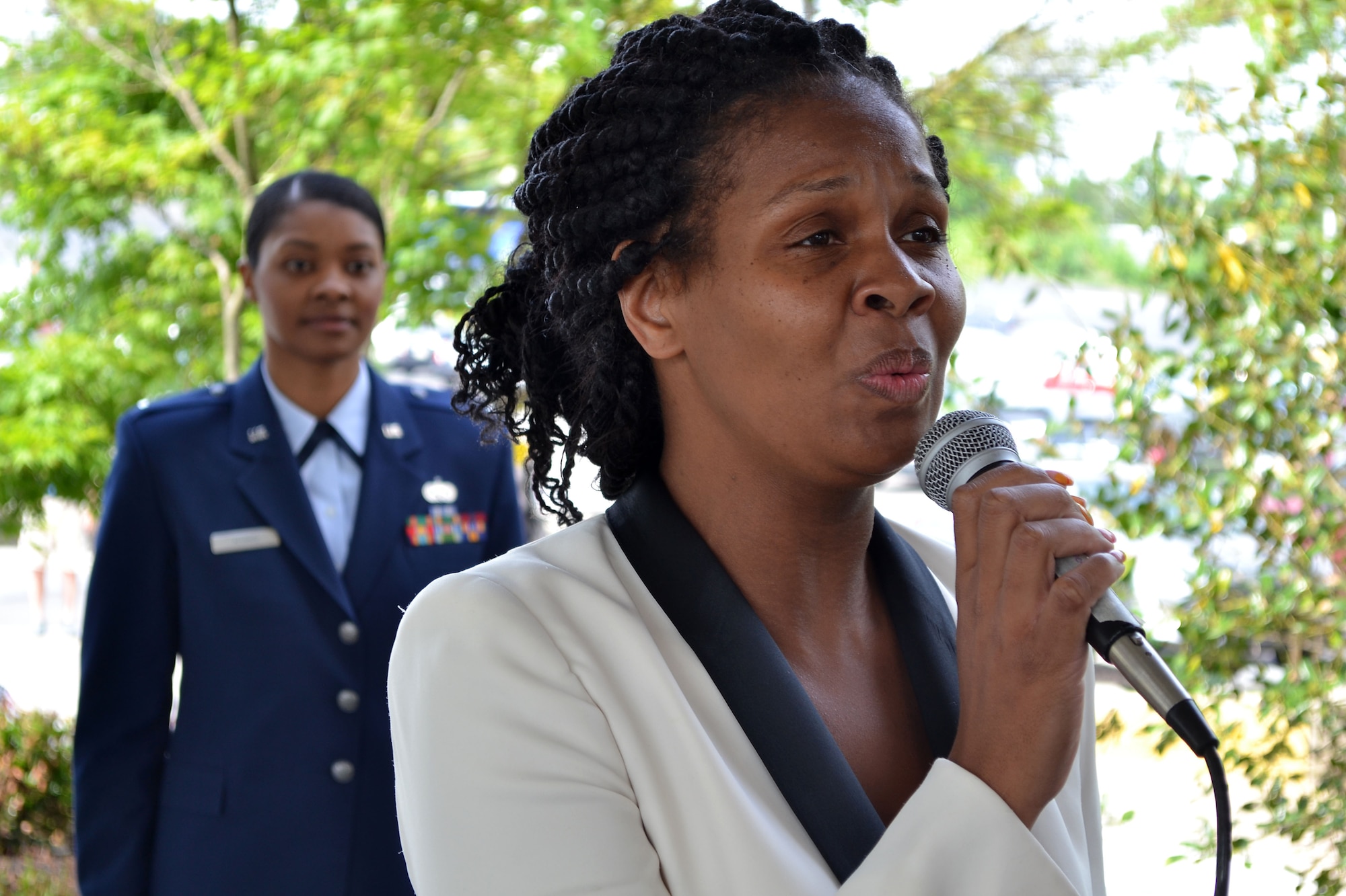 Opening the Valley Forge Casino's 2015 Armed Forces Day recognition event, May 16, 2015, Tasha Moore, banquet captain with the casino, belts an a cappella rendition of the national anthem. First Lt. Charese Adams, logistic readiness office with the 201st RED HORSE, Detachment 1, was this year's keynote speaker during the ceremony. (U.S. Air National Guard photo by Master Sgt. Christopher Botzum/Released)