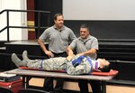 Ralph Jimenez (left) and Ronny Garcia, Tampa Fire Department training coordinators, present their “Street Smart” help demonstration highlighting the dangers of driving intoxicated and not wear a seat belt with the help of Staff Sgt. Homero Carrillo, 902nd Security Forces Squadron, during a Wingman Day presentation May 29 at Joint Base San Antonio-Randolph. Wingman Day provides a foundation to build and sustain a culture of comprehensive fit Airman and civilian employees, strengthen resiliency and promotes safety on and off duty. (U.S. Air Force photo by Harold China)