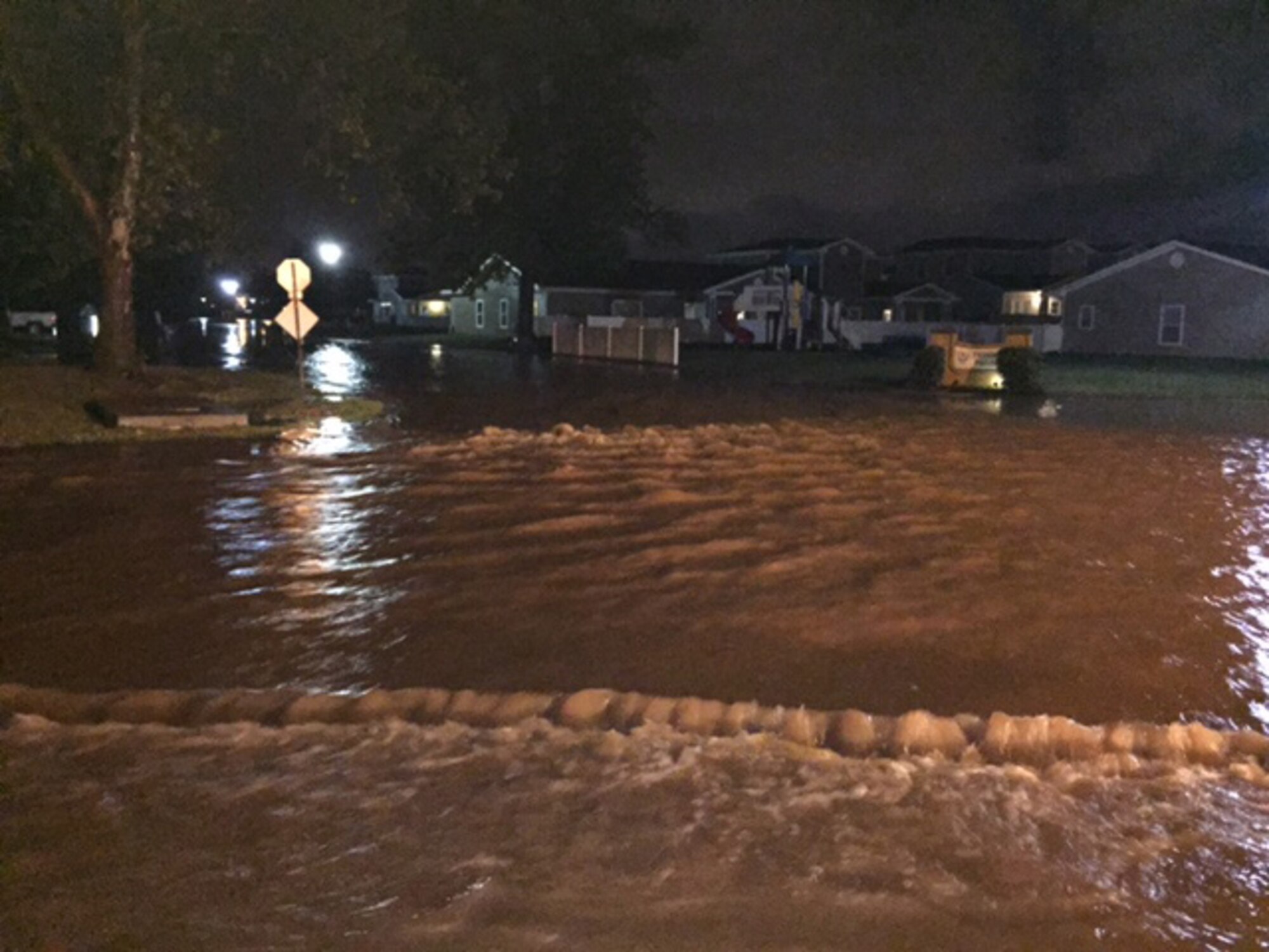 Water rushes through the streets of base housing in the very early morning hours of May 23. Only four of the 660 homes in base housing suffered water damage. (Courtesy photo/Released)