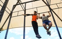 Thomas Stillings (left), exercises with his father, Rohm Stillings, Air Education Training Command T-X program analyst at Joint Base San Antonio-Randolph, June 6 at the JBSA-Randolph Rambler Fitness Center.  (U.S. Air Force photo by Senior Airman Alexandria Slade)

