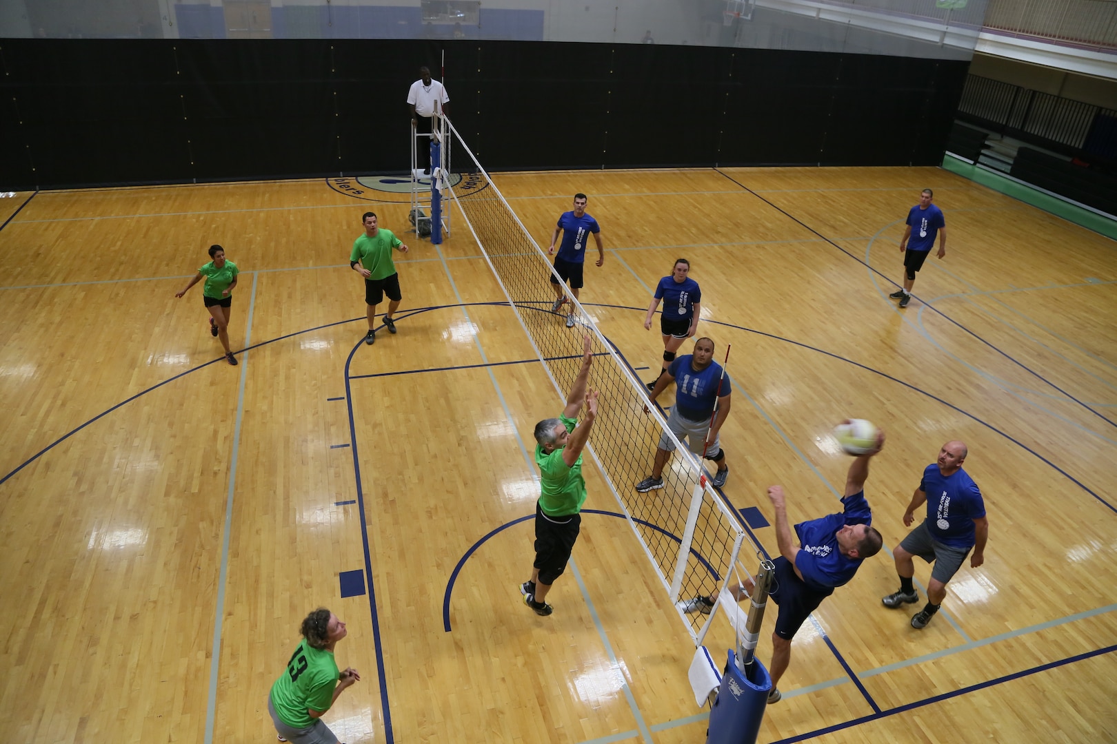 Members of the Air Education and Training Command headquarters volleyball team prepare to return a ball after a strike from the opposite team June 3 during the Joint Base San Antonio intramural volleyball championships at the JBSA-Randolph Rambler Fitness Center.  (U.S. Air Force photo by Senior Airman Alexandria Slade)
