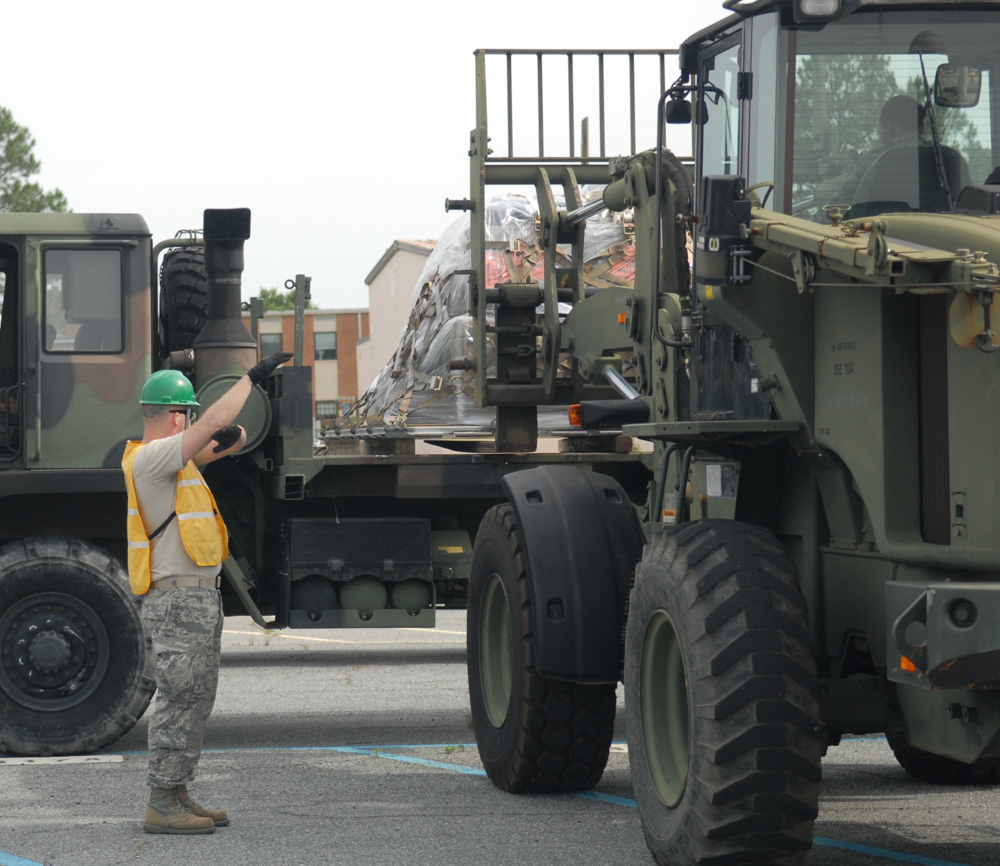 A 51st Combat Communications Squadron airman guides a forklift into place to safely deliver a pallet, May 14, 2015. This is part of the unit’s behind-the-scenes deployment work. (U.S. Air Force photo by Misuzu Allen)