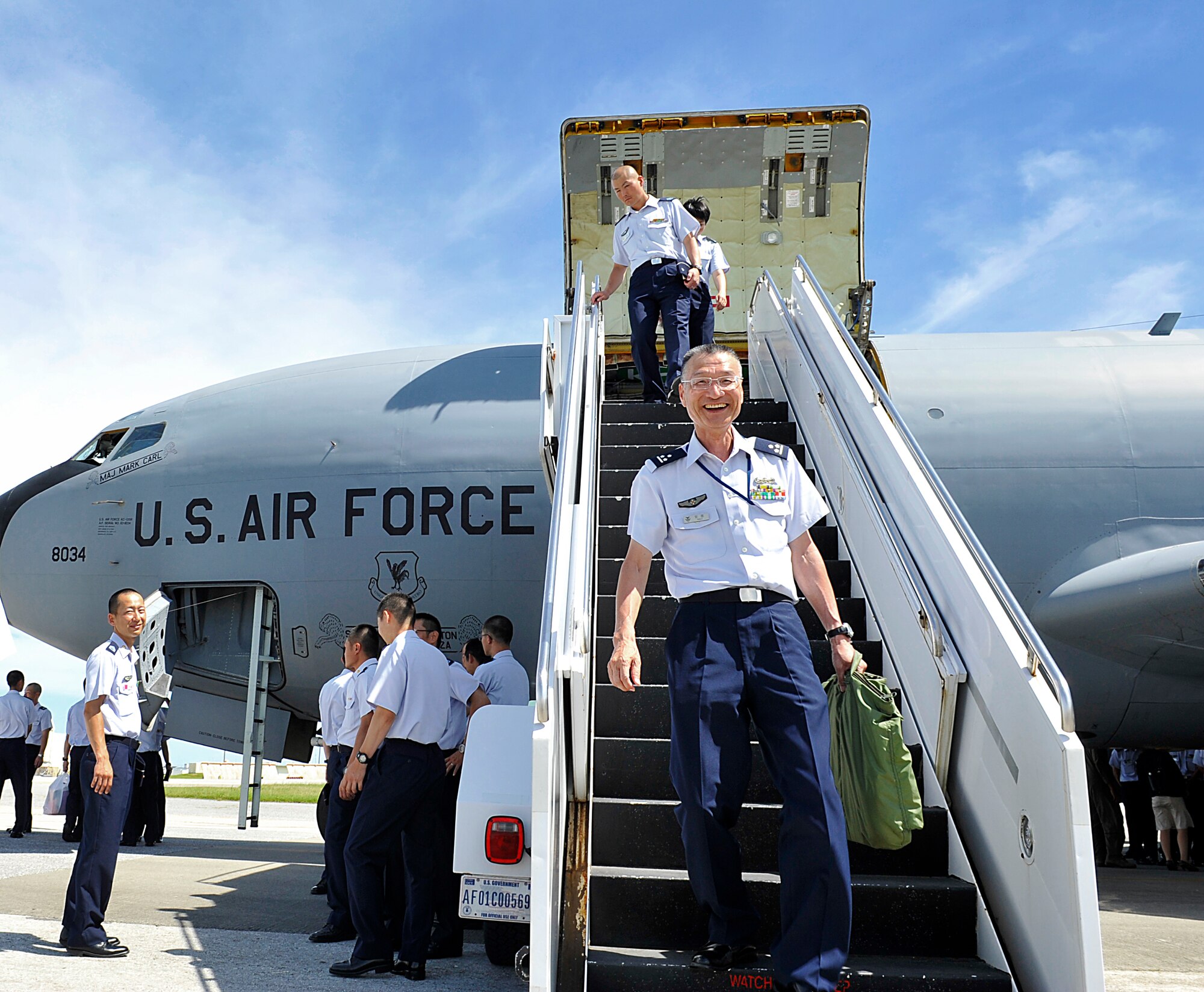 Japan Air Self-Defense Force Capt. Yasushi Takayoshi, cadet instructor, descends from a 909th Air Refueling Squadron KC-135 Stratotanker during an officer candidate school tour at Kadena Air Base, Japan, June 11, 2015. More than 70 JASDF cadets had the chance to interact with Airmen and learn about the 18th Wing's mission and its capabilities during the tour. (U.S. Air Force photo by Naoto Anazawa)