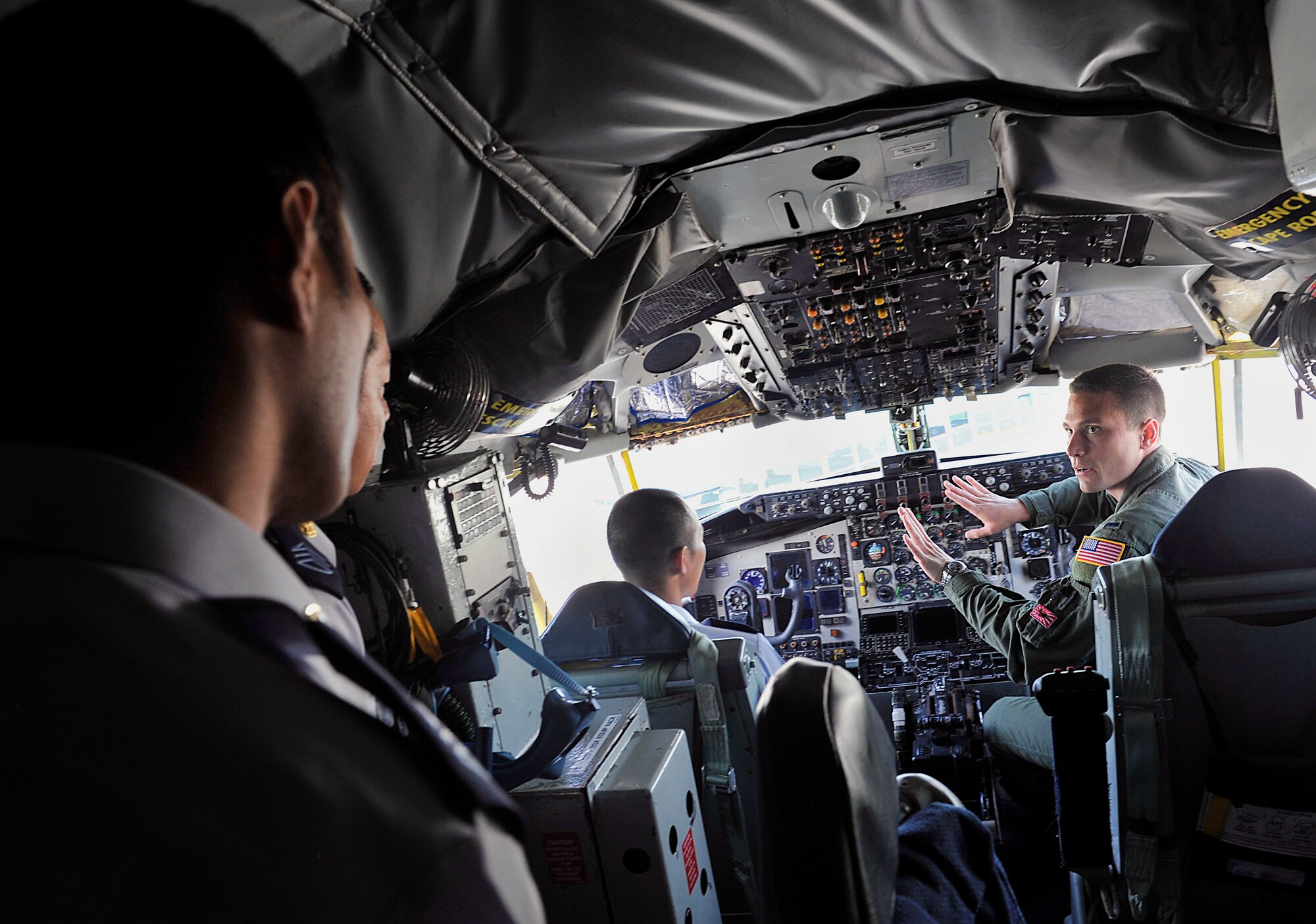 U.S. Air Force 1st Lt. Stephen Conroy, 909th Air Refueling Squadron co-pilot, explains a KC-135 Stratotanker's operations to Japan Air Self-Defense Force officer candidate school cadets while inside a cockpit during a tour at Kadena Air Base, Japan, June 11, 2015. The tour gave the cadets a better understanding of the missions and operations of U.S. military bases on Okinawa. (U.S. Air Force photo by Naoto Anazawa)