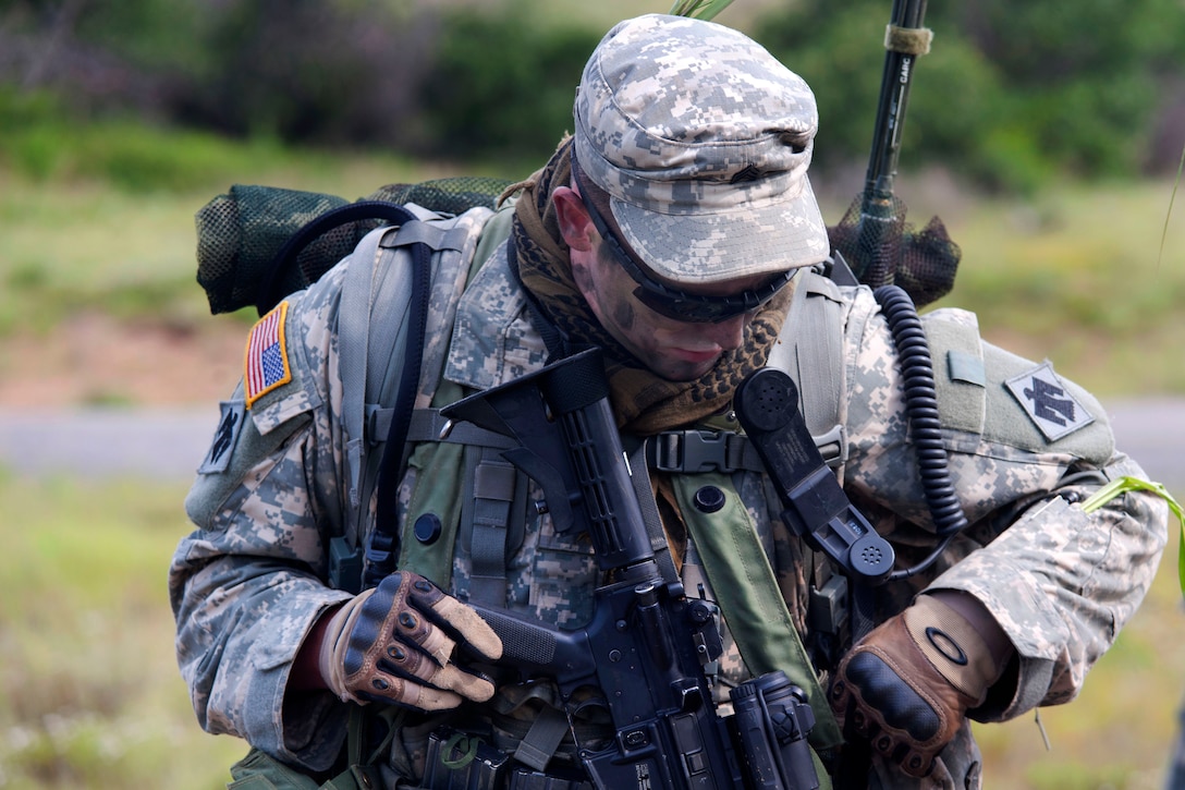 Oklahoma Army National Guard Sgt. Ryan McKey prepares for a ...