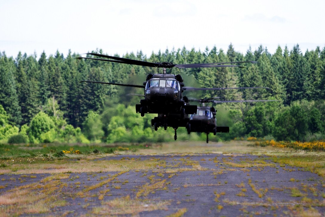 Army UH-60 Black Hawks take off at Joint Base Lewis-McChord, Wash., June 4, 2015, to support a static-line jump by soldiers from the Army's 1st Special Forces Group. The helicopter crews are assigned to the 16th Combat Aviation Brigade. More than 100 soldiers jumped from an altitude of approximately 1,500 feet during the event . 
