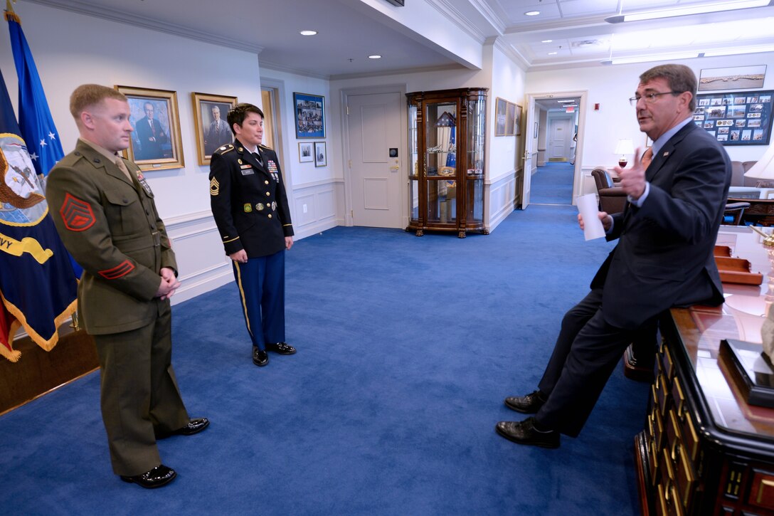 Defense Secretary Ash Carter talks with Marine Corps Staff Sgt. Seth B. Densford, the Office of the Secretary of Defense's junior enlisted service member of the year, and Army Master Sgt. Kimberly L. Baker, the Office of the Secretary of Defense's senior enlisted service member of the year, at the Pentagon, June 12, 2015. 