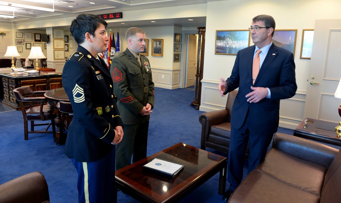 Defense Secretary Ash Carter talks with Marine Corps Staff Sgt. Seth B. Densford, the Office of the Secretary of Defense's junior enlisted service member of the year, and Army Master Sgt. Kimberly L. Baker, the Office of the Secretary of Defense's senior enlisted service member of the year, at the Pentagon, June 12, 2015. 