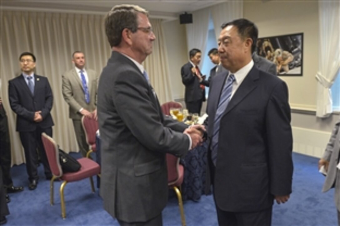 U.S. Defense Secretary Ash Carter greets Chinese Gen. Fan Changlong, vice chairman of China's Central Military Commission, as they prepare to sit down for a dinner at the Pentagon June 11, 2015. The two leaders met earlier in the day to discuss key issues of mutual concern.