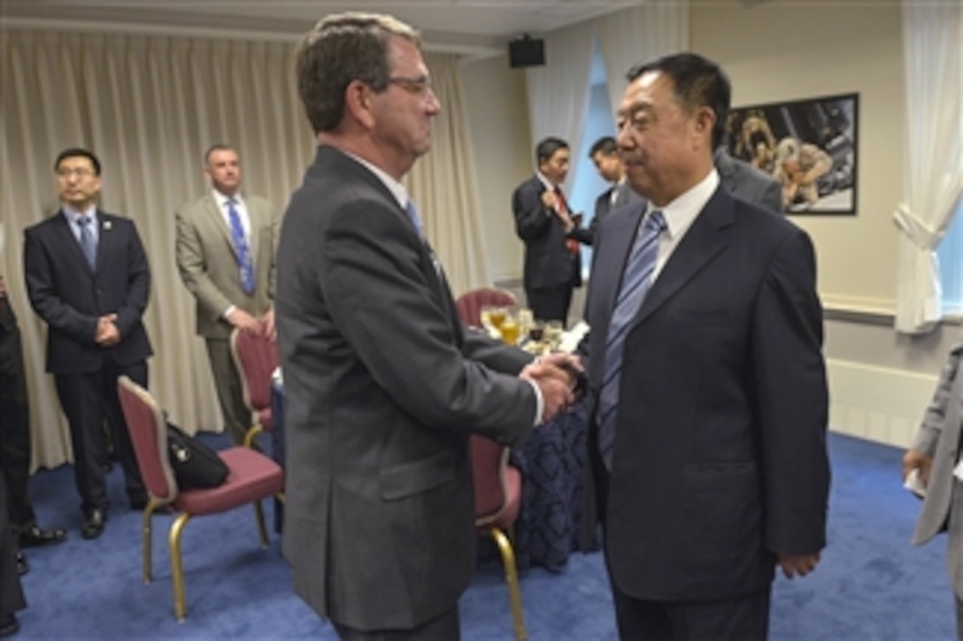 U.S. Defense Secretary Ash Carter greets Chinese Gen. Fan Changlong, vice chairman of China's Central Military Commission, as they prepare to sit down for a dinner at the Pentagon June 11, 2015. 