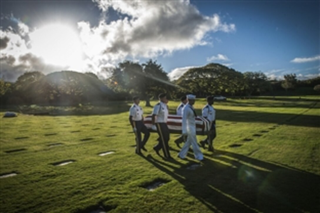 Service members from the Defense POW/MIA Accounting Agency escort the recently disinterred remains of a service member from the USS Oklahoma previously buried as unknown during a ceremony at the National Memorial Cemetery of the Pacific in Honolulu, June 8, 2015.  The disinterment was part of an effort to identify the U.S. service members.  