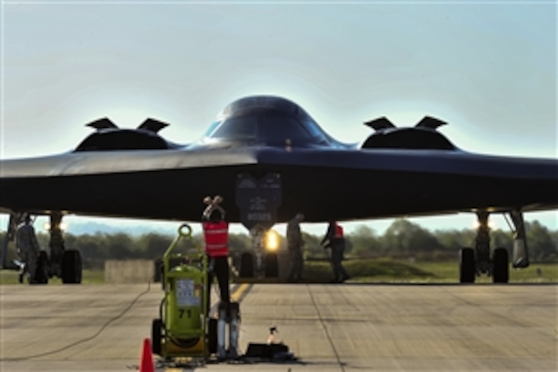 A U.S. airman guides a B-2 Spirit, known as the stealth bomber, for refueling during Saber Strike 15 on Royal Air Force Fairford, England, June 7, 2015. The exercise demonstrates the aircraft's capabilities to forward-deploy and deliver conventional and nuclear deterrence.