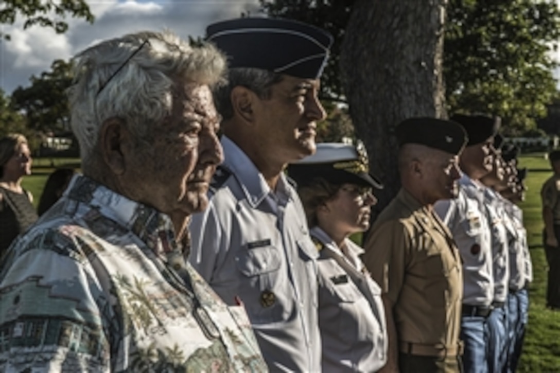 Ray Emory, Air Force Maj. Gen. Kelley K. McKeague, Navy Rear Adm. Kathy Creighton and members of the Defense POW/MIA Accounting Agency participate in a disinterment ceremony at the National Memorial Cemetery of the Pacific in Honolulu, June 8, 2015. The agency conducts disinterments to identify U.S. service members from the USS Oklahoma buried as unknowns. MeKeague is the agency's deputy director and Emory is a Pearl Harbor survivor.