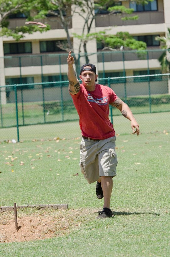 Participant Shayne Rollings, a Marine Aviation Logistics Squadron 24 Sailor, takes his turn during the 101 Days of Summer Horseshoe Tournament at Riseley Field, June 10, 2015. The double-elimination tournament, which runs through June 19, has 14 teams competing. (U.S. Marine Corps photo Kristen Wong/Released)
