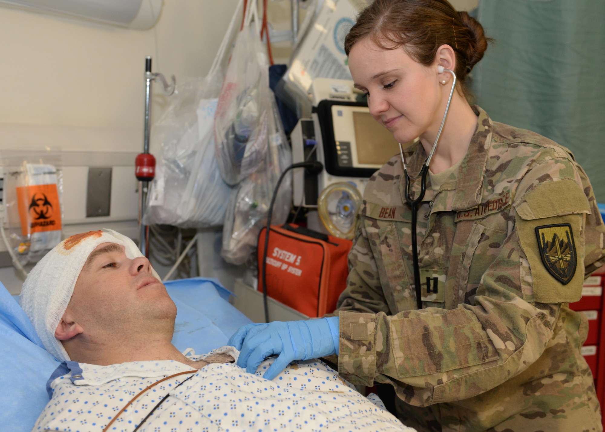 U.S. Air Force Capt. Mavis Bean, 455th Expeditionary Medical Operations Squadron clinical nurse, checks vital signs on a volunteer training patient June 11, 2015, at Bagram Airfield Afghanistan. Bean works in the intensive care unit at Afghanistan’s most advanced medical facility, the Craig Joint Theater Hospital, and is responsible for treating trauma patients. (U.S. Air Force photo by Senior Airmen Cierra Presentado/Released)