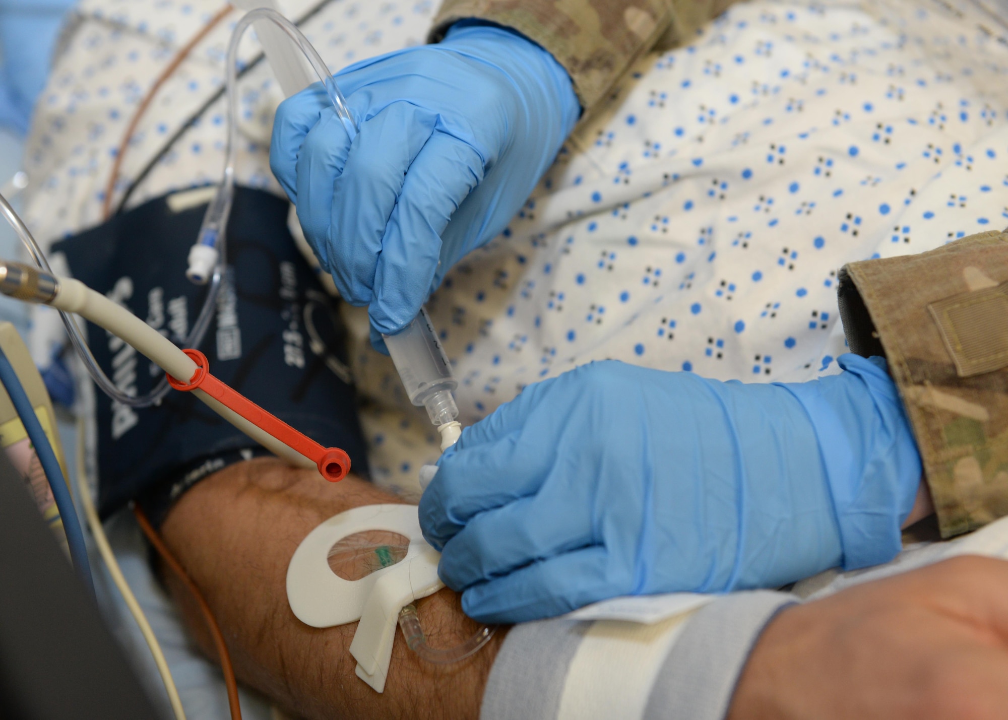 U.S. Air Force Capt. Mavis Bean, 455th Expeditionary Medical Operations Squadron clinical nurse, simulates placing I.V. fluids in a volunteer training patients arm June 11, 2015, at Bagram Airfield, Afghanistan. Bean works in the intensive care unit at Afghanistan’s most advanced medical facility, the Craig Joint Theater Hospital, and is responsible for treating trauma patients. (U.S. Air Force photo by Senior Airmen Cierra Presentado/Released)