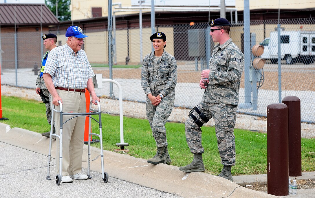 Albert R. St. Germain, a resident of Grandview, Mo., reminisces with members of the 509th Security Forces Squadron June 13, 2015, during the Wings Over Whiteman air show at Whiteman Air Force Base, Mo. During the air show, visitors of the base had the opportunity to see the inner workings of a military installation and talk with service members. (U.S. Air Force photo by Airman 1st Class Jazmin Smith/Released)