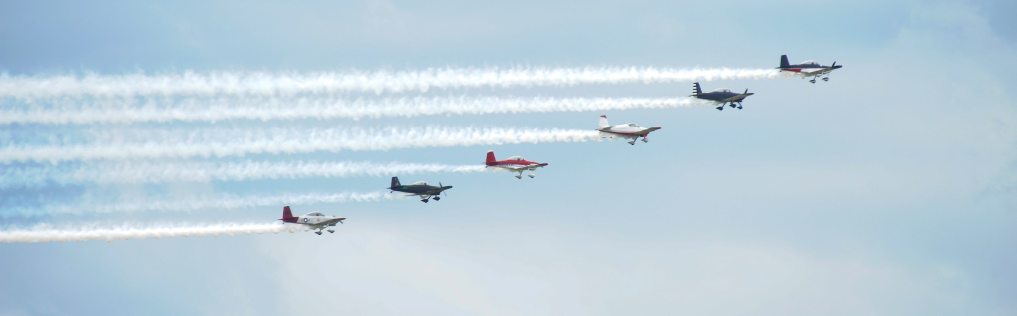 A fleet of P-51 Mustangs show off for a crowd June 13, 2015, during the Wings Over Whiteman air show at Whiteman Air Force Base, Mo. Air shows are one of the largest ways during the year that military installations show their appreciation for ongoing community support. (U.S. Air Force photo by Staff Sgt. Brigitte N. Brantley/Released)